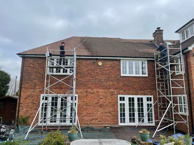 Roof cleaning carried out safely from scaffold towers by The Roof Moss Cleaners in Leighton Buzzard